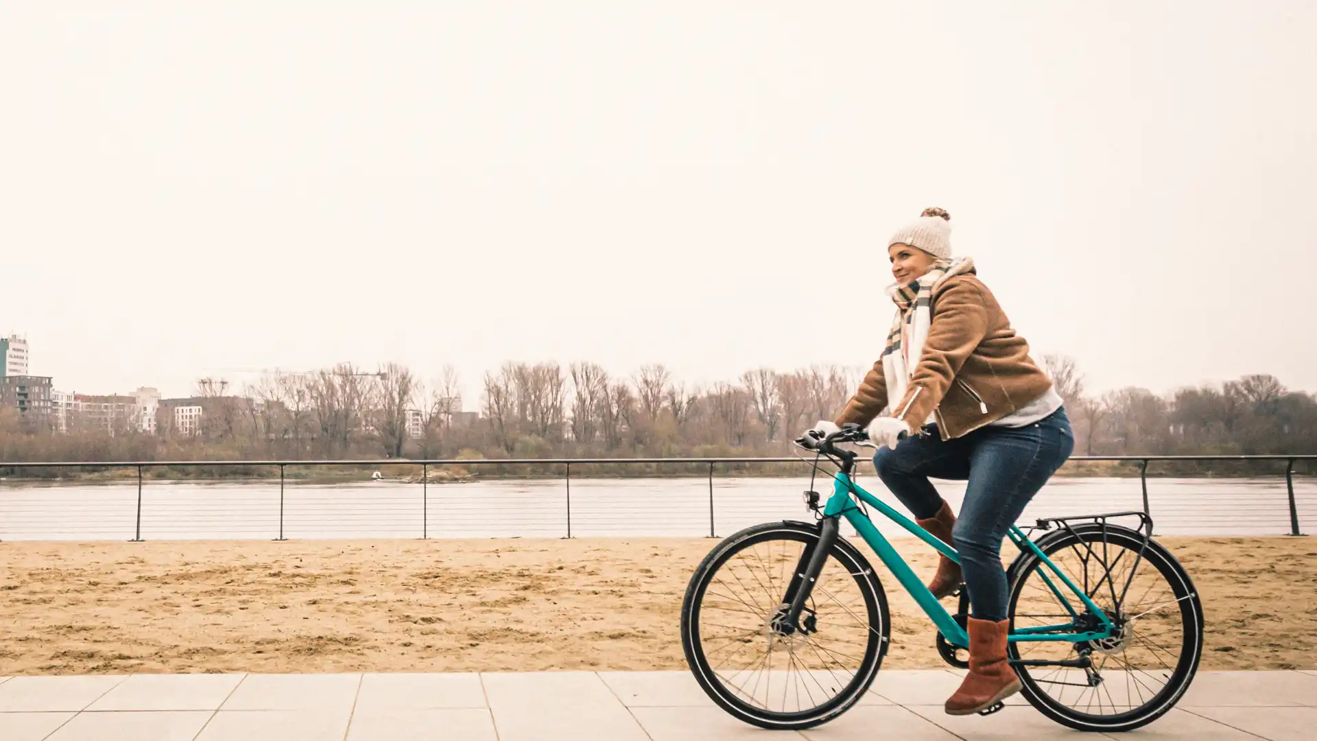 woman riding e-bike in winter
